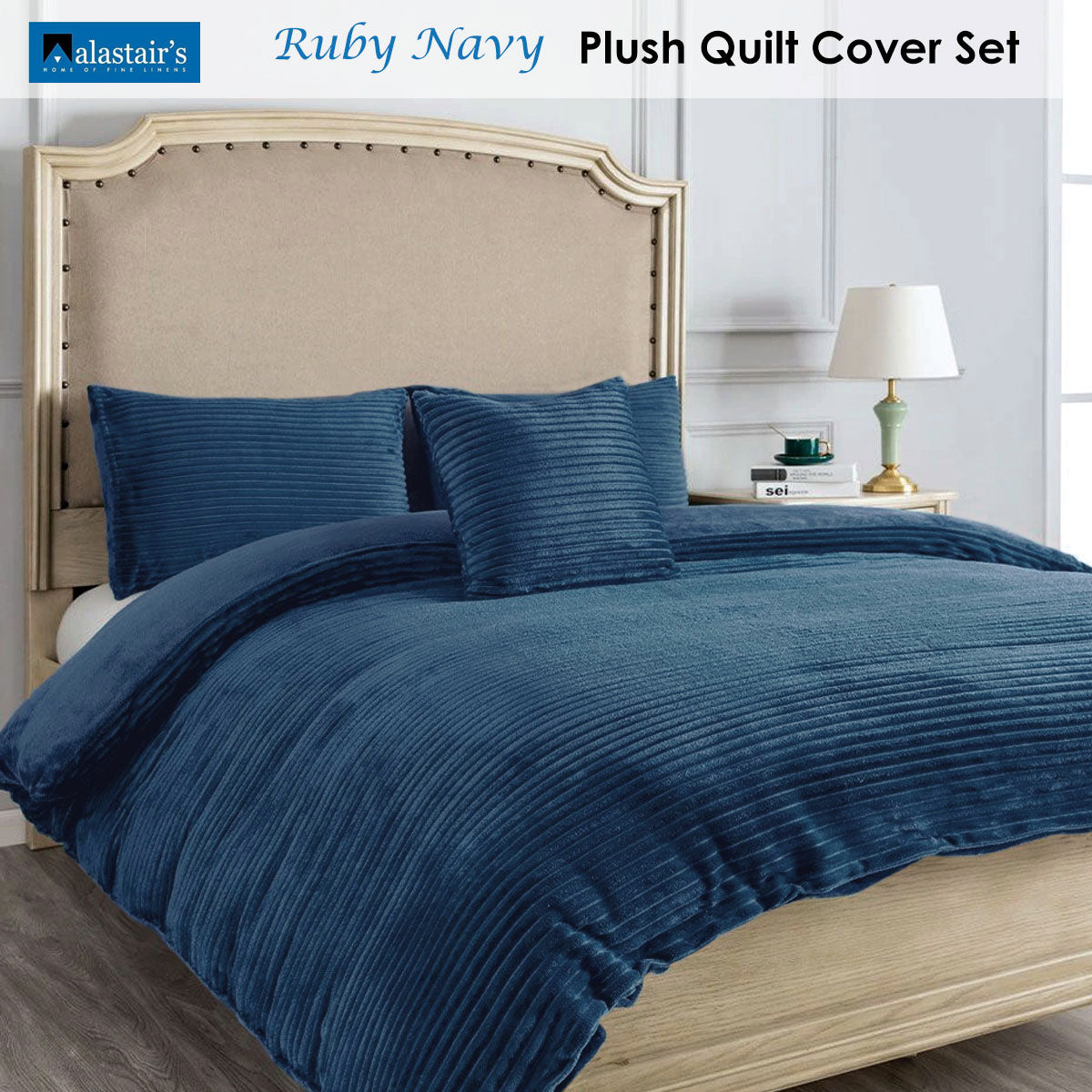 Ruby Navy Quilt Cover Set Double in plush textured fabric on a bed with beige headboard and bedside lamp