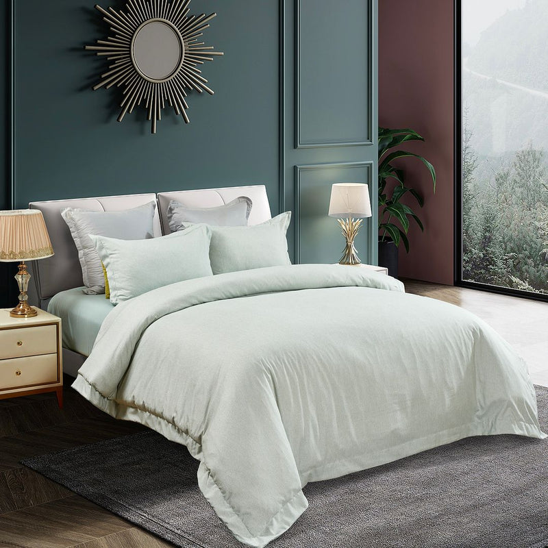 Tailored Super Soft Quilt Cover Set - Super King Size in soft light green on bed with pillows, bedside tables and lamps