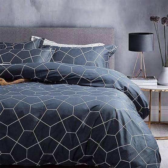 Chelsea King Size Duvet Doona Quilt Cover Set in dark geometric pattern on bed with bedside table and lamp