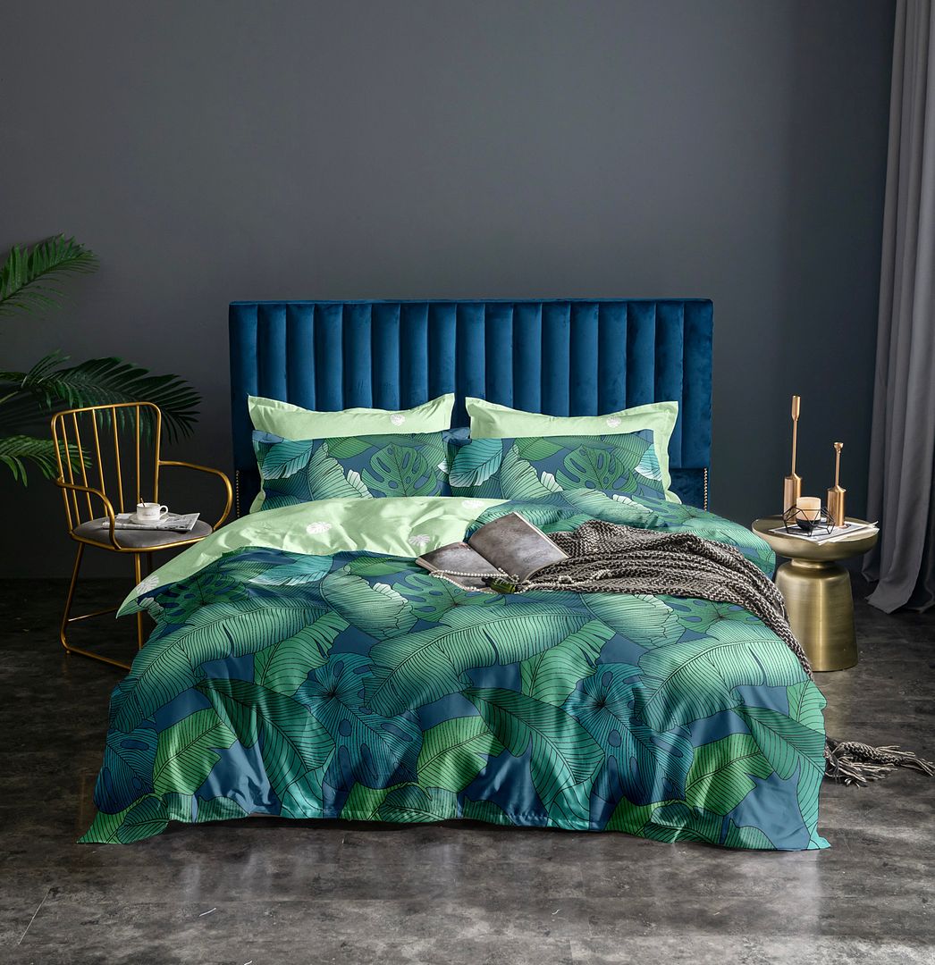 Kalena Leaves Quilt Cover Set - Queen Size with green leaf pattern on bedzy bed and velvet blue headboard in modern bedroom
