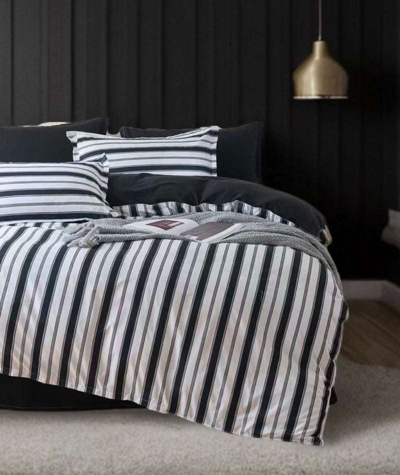 Ascar Striped Quilt Cover Set - Super King Size with black and white striped design on bed in modern bedroom setting
