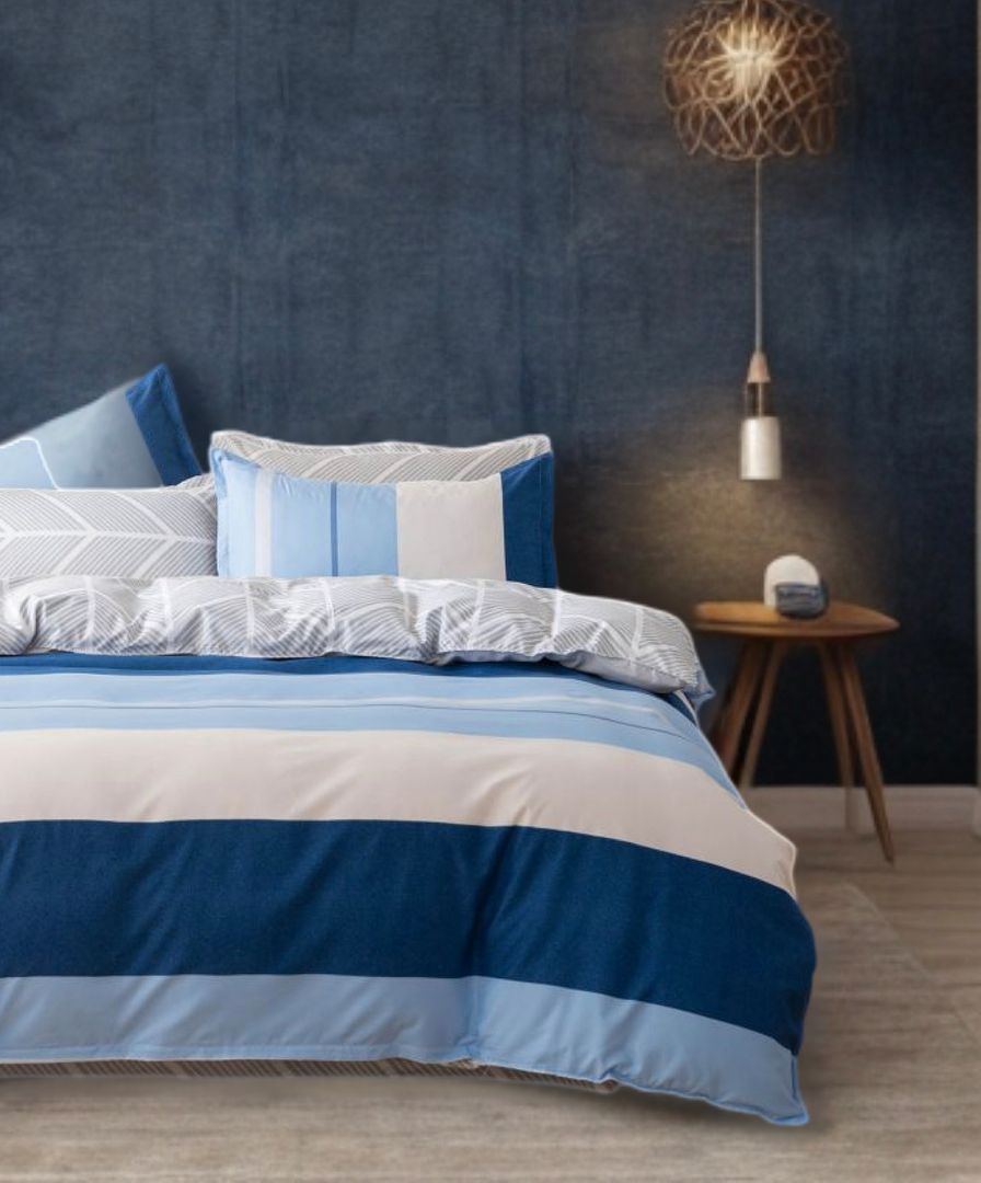 Mannix Striped Quilt Cover Set - Super King Size in blue and white stripes on a bed with pillows and bedside table