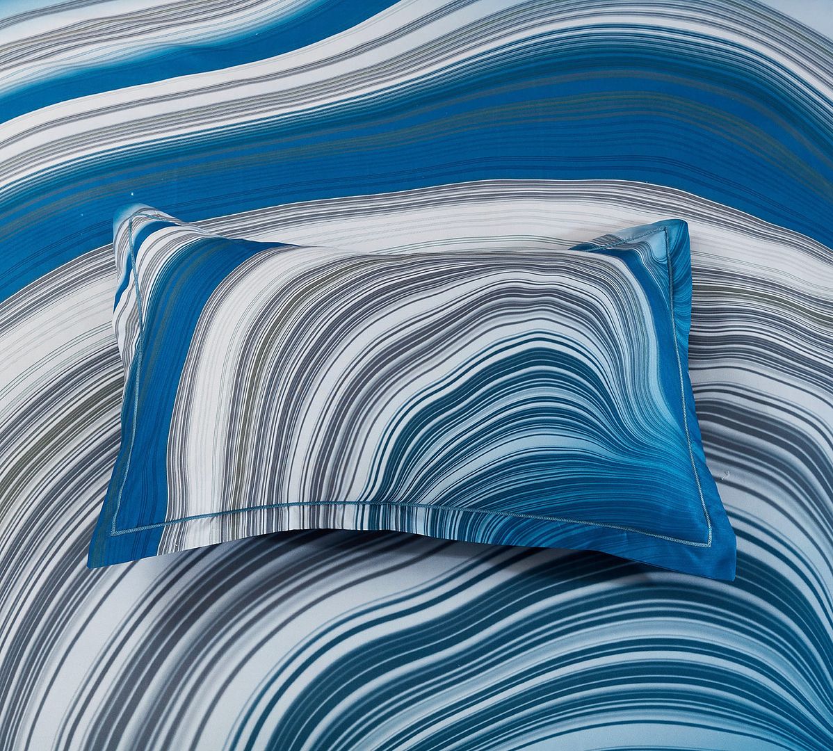 Evienne Quilt Cover Set - King Size with swirling blue, gray, and white wave pattern on pillow and cover