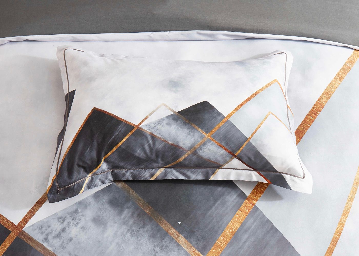 Dakuta Quilt Cover Set - Queen Size featuring abstract gray and gold geometric patterns on pillow and cover.