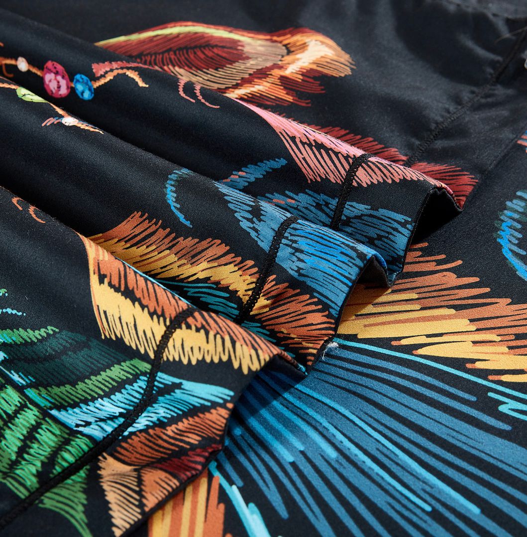 Close-up of colorful feather patterns on black fabric from the Dream Catcher Quilt Cover Set - Queen Size by Bedzy