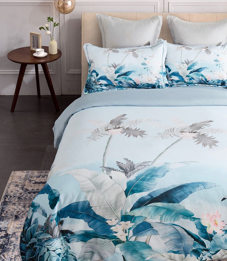Tropical Quilt Cover Set - Queen Size with blue and white botanical print, styled on a modern upholstered bed by Bedzy.