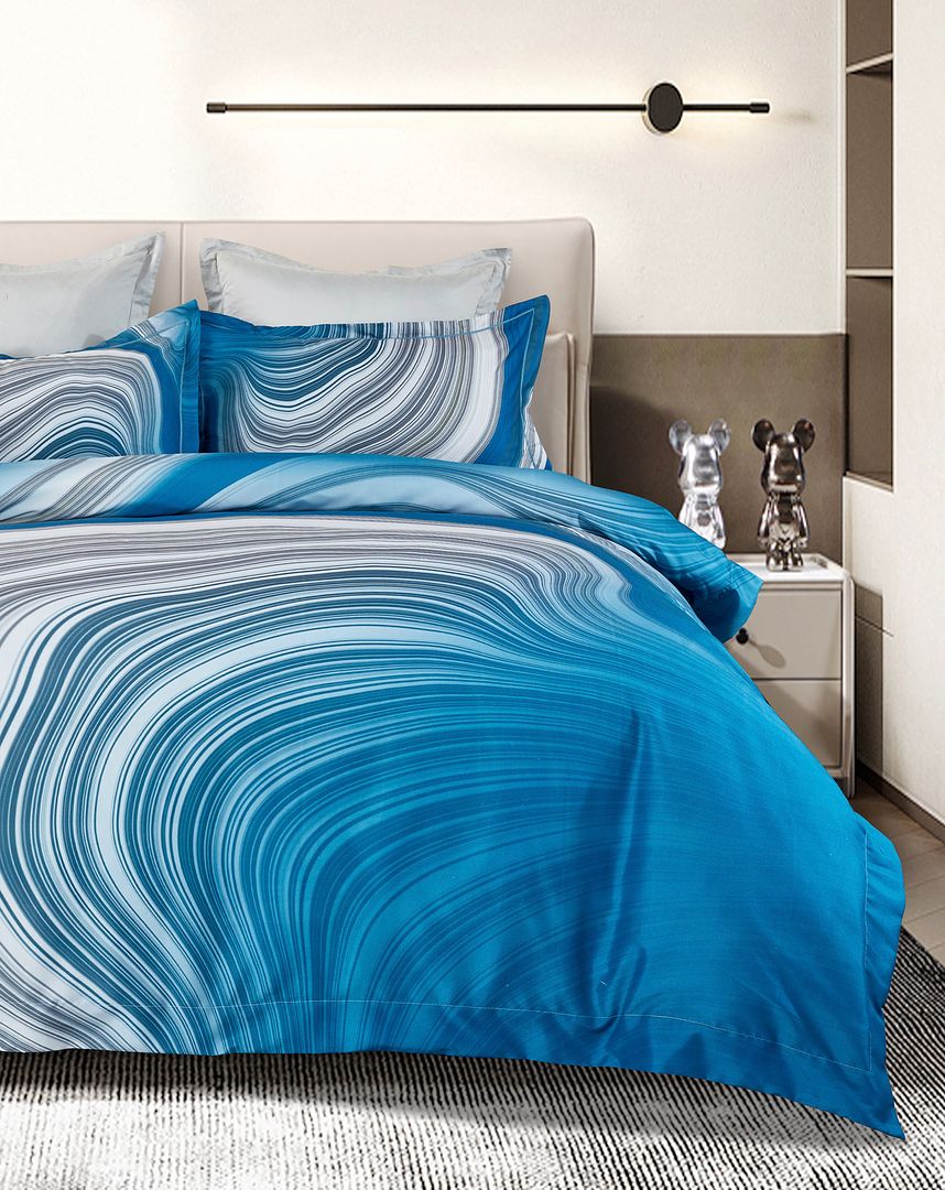 Evienne Quilt Cover Set - Super King Size with blue and white swirl pattern on bed in modern bedroom setup