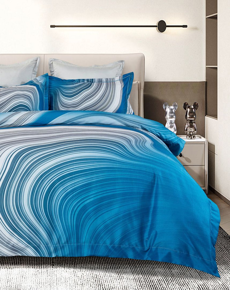 Evienne Quilt Cover Set - Super King Size with blue and white swirl pattern on bed in modern bedroom setup
