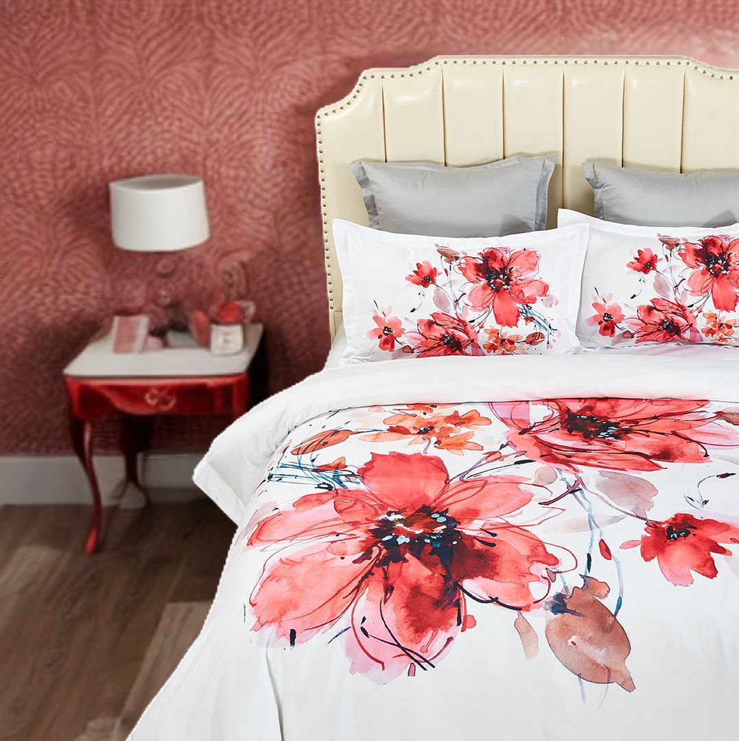 Lulani Floral Quilt Cover Set - Super King Size with red floral design on white bedding in bedroom setting with cream headboard and red bedside table