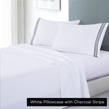 White soft microfibre sheet set with colourful embroidered stripe king charcoal stripe on bed with matching pillowcases in bright room
