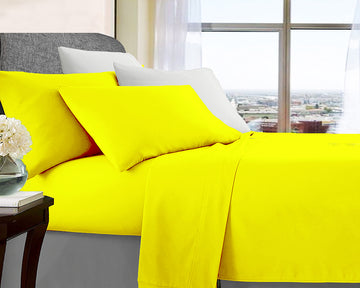 ultra soft microfibre sheet set mega king yellow on neatly made bed with white pillows in bright bedroom setting