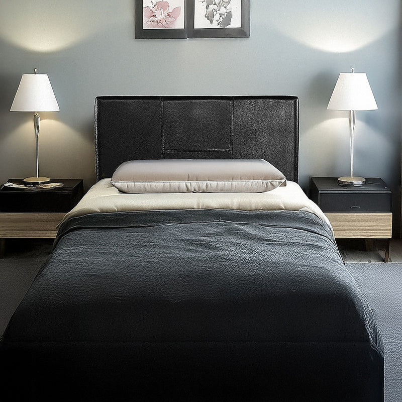 Single Size | Bed Headboard (Black) with stitched design, shown in a modern bedroom setting with bedside lamps.