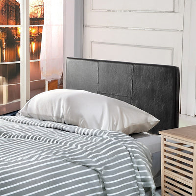 Single Size | Bed Headboard (Black) with stitched detail, shown in a bedroom setting with striped bedding and wooden side table