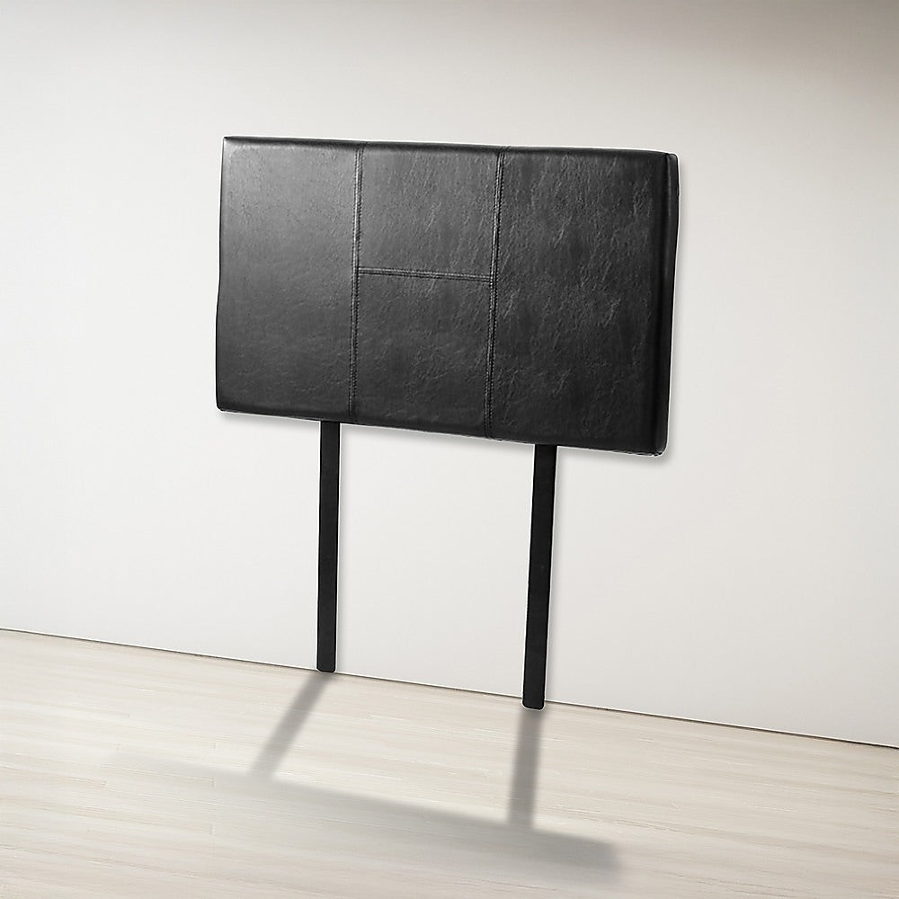 Single Size | Bed Headboard (Black) with stitched panel design, black upholstery, standing against white wall in bedroom furniture setup