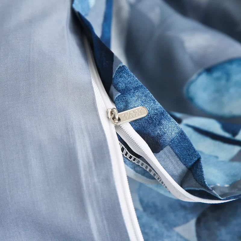 Close-up of zipper detail on Timeless Design Plaid Duvet Cover Set - Lightweight-King with blue patterned fabric and stitching