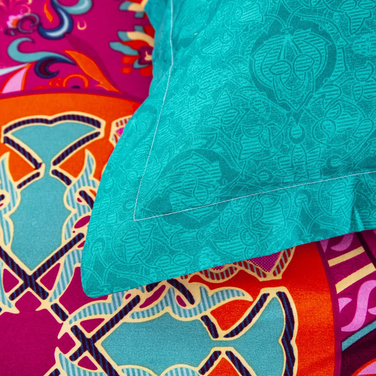Close-up of vibrant floral patterned bedding with turquoise sham from Aesthetic Glow Floral 3‑Piece Comforter Set with Matching Shams