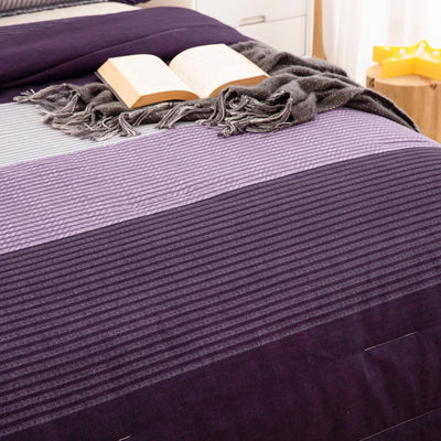 Urban Nest 3‑Piece Comforter Collection – Fresh Room Aesthetic with striped purple tones, gray throw, and open book on bed