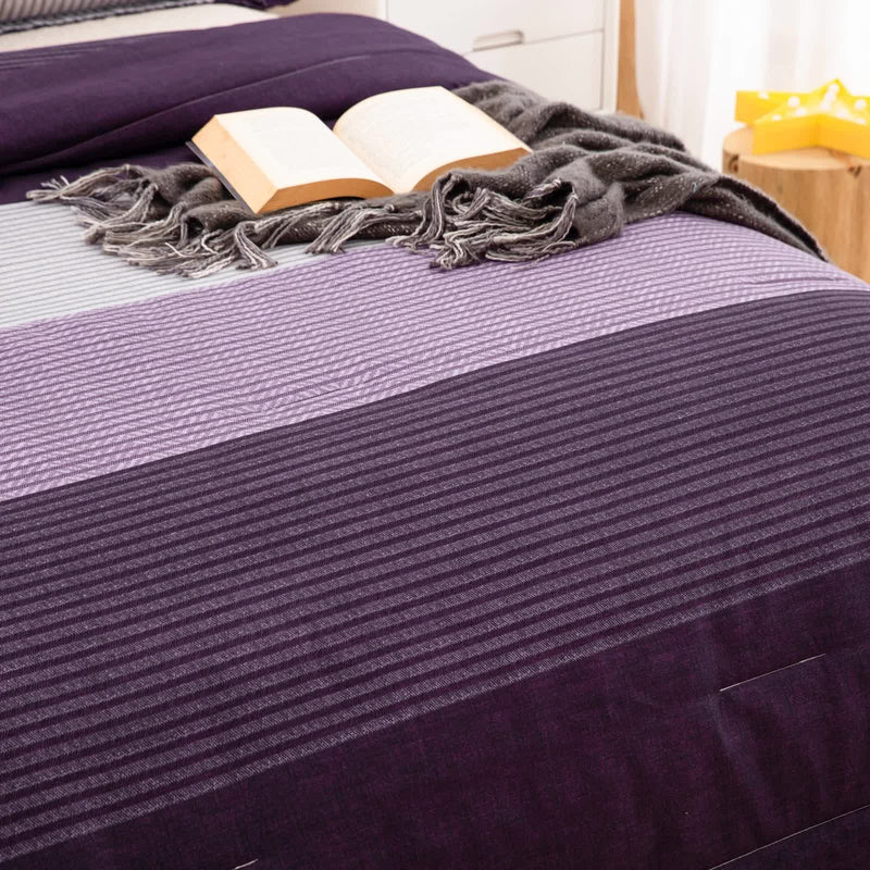 Urban Nest 3‑Piece Comforter Collection – Fresh Room Aesthetic with striped purple tones, gray throw, and open book on bed