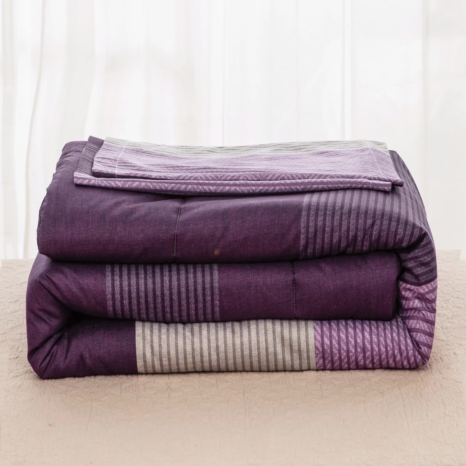 Folded purple patterned comforter from Urban Nest 3‑Piece Comforter Collection – Fresh Room Aesthetic on beige surface