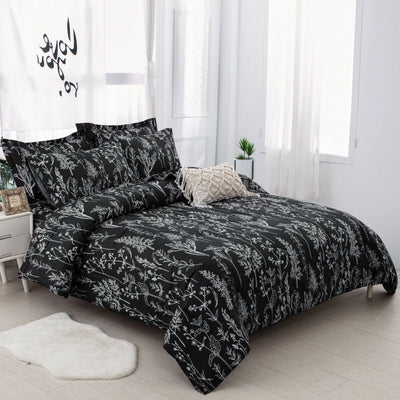 Floral Leaves Comforter Set, King Size, Microfiber Quilted Bedding with Pillowcase in black with white botanical print on bed in bright room