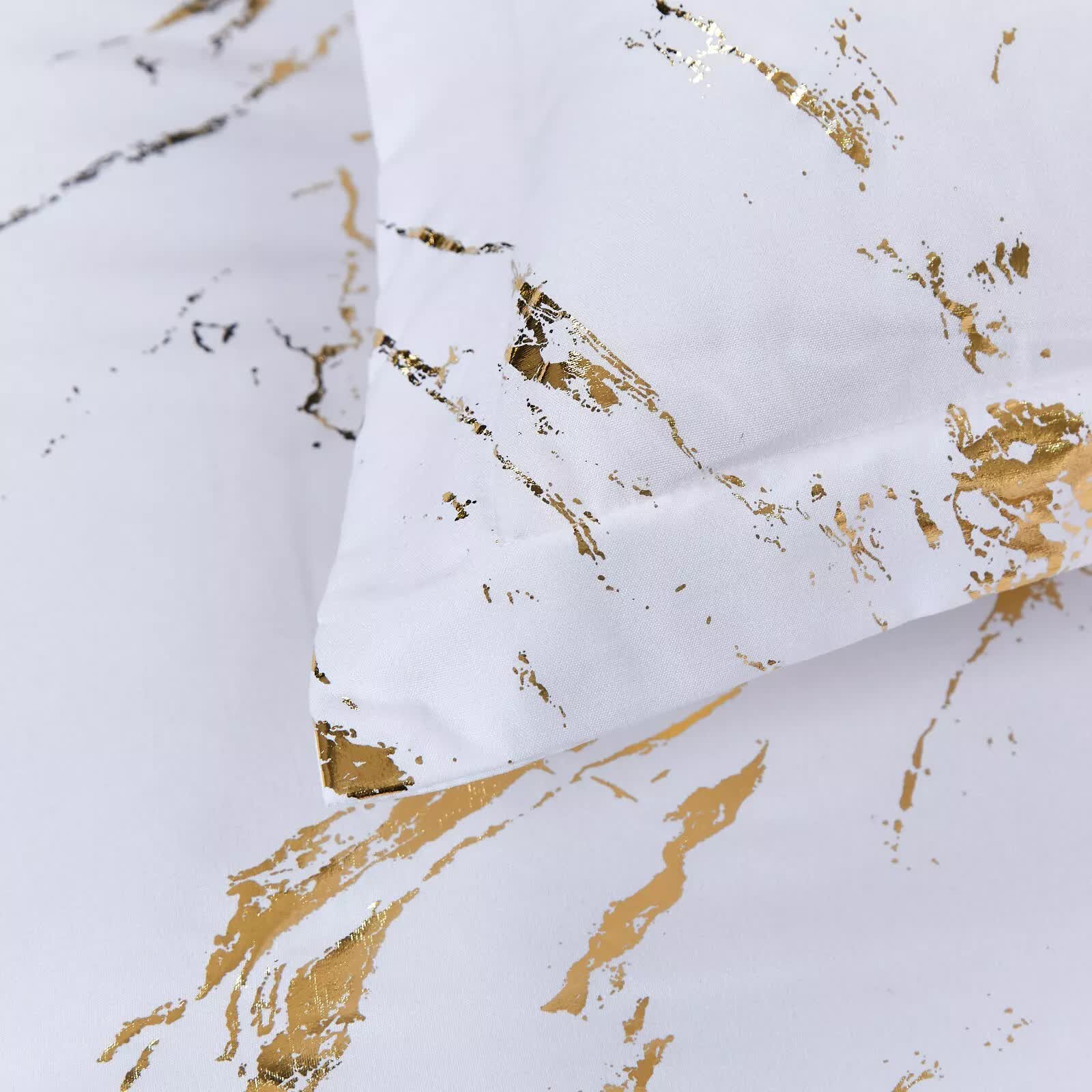 Cloud Rest Bedding Collection – Minimal 3‑Piece Comforter with white fabric and gold abstract print, close-up on bedding texture