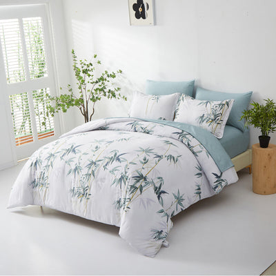 Floral Leaves Comforter Set, King Size, Quilted Bedding with Pillowcases on bed with blue pillows in bright bedroom