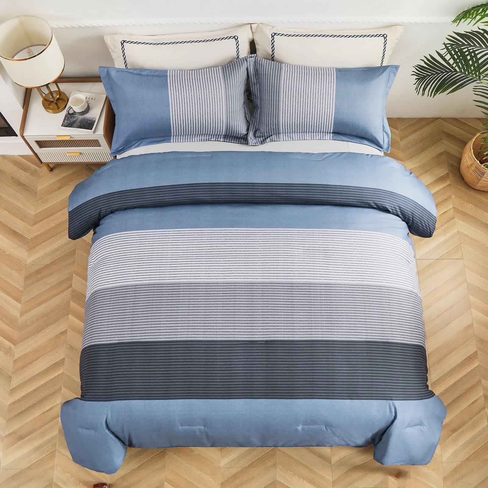 Coastal Drift striped Comforter Bundle – Breezy 3-Piece Bedding in blue and gray tones on made bed with pillows