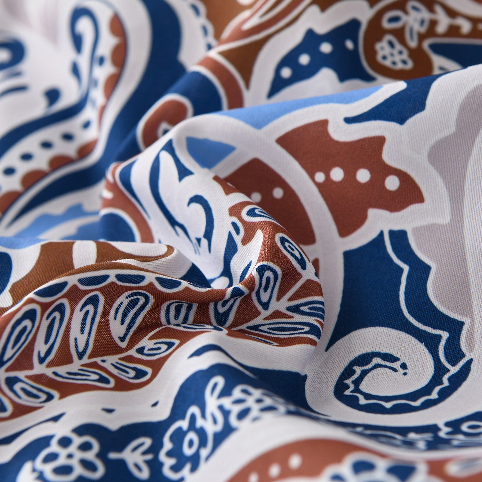 Close-up of blue and brown patterned fabric from the Floral Stripes Comforter Set, King Size, Elegant 3-Piece Bedding with Pillowcases