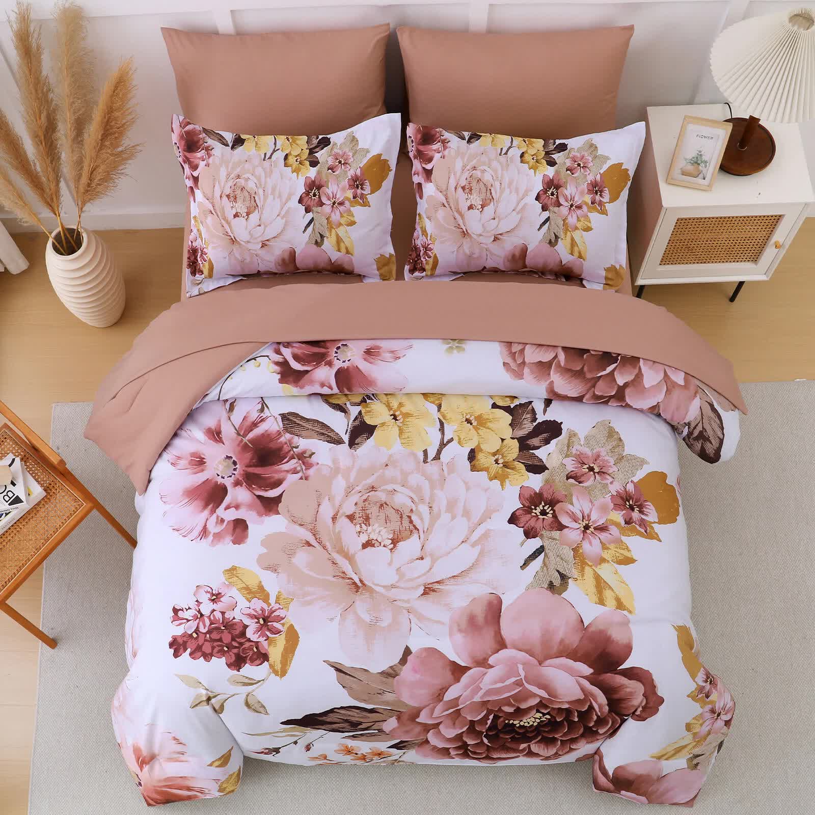 Pure Haven Pink floral 3‑Piece Comforter Set with large floral print, matching pillow shams, and solid pink back, styled on bed.