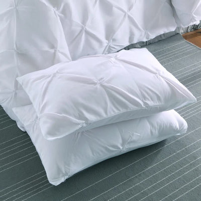Minimal Mood white Comforter Collection – Modern 3‑Piece Set featuring textured white comforter and matching pillows on striped rug