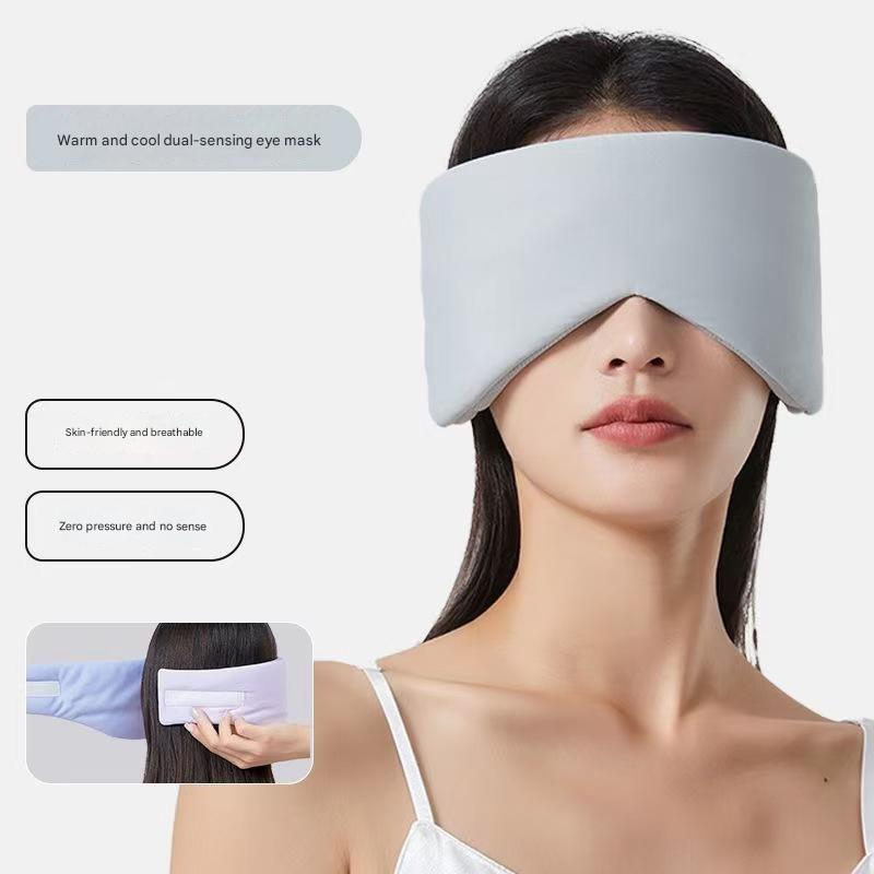 Grey Reversible All-Season Sleep Mask - Cooling & Warming with Sound Muffling Ear Covers shown worn on model’s face and held at back