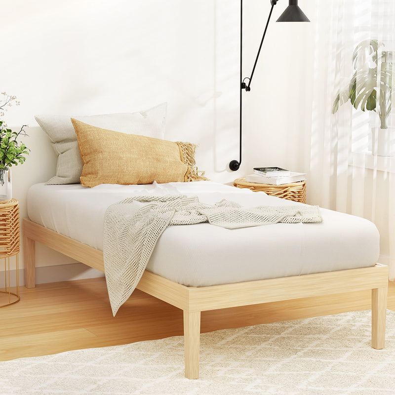 Bruno Minimalist Single Solid Pinewood Bed Frame with light wood finish styled with neutral bedding and cozy pillows in bright room