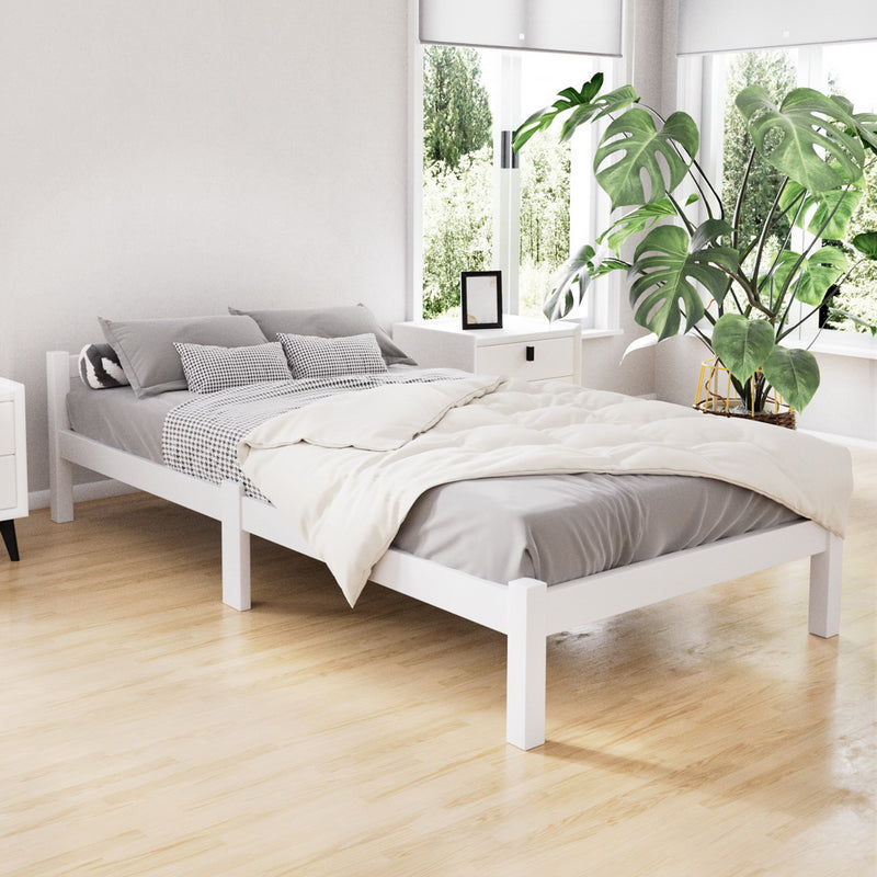 Gibson Wooden Single Bed Frame White in a bright bedroom with bedding and bedside table, showcasing solid pine wood design
