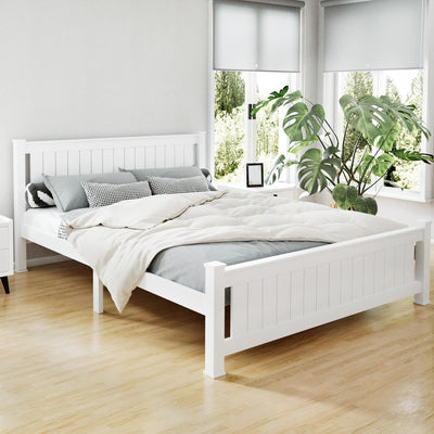 Cottesloe Wooden Queen Bed White with slatted headboard and footboard in bright bedroom with plants and natural light