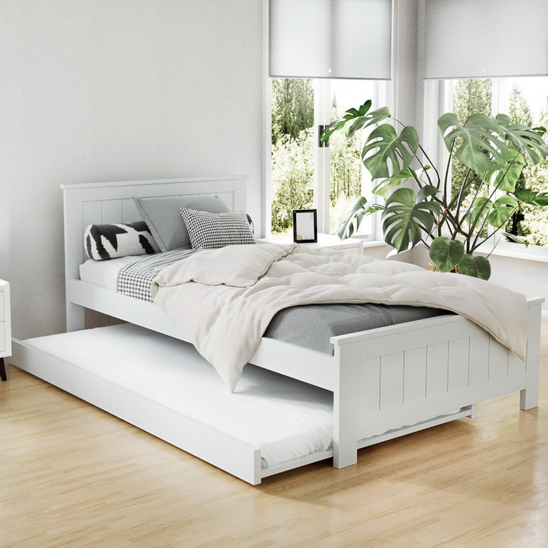 Kids Elvis Wooden King Single Trundle Bed Frame White in a bright bedroom with pillows and bedding on wooden floor