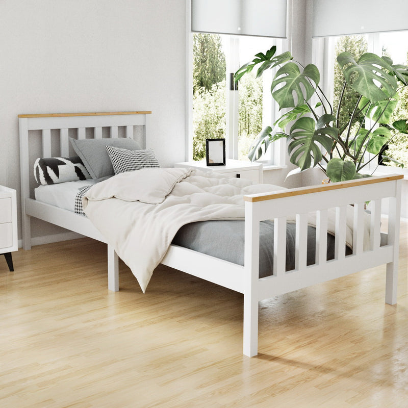 Kewarra Wooden Single Bed Frame White in a bright bedroom with bedding, bedside table, and large green plant nearby