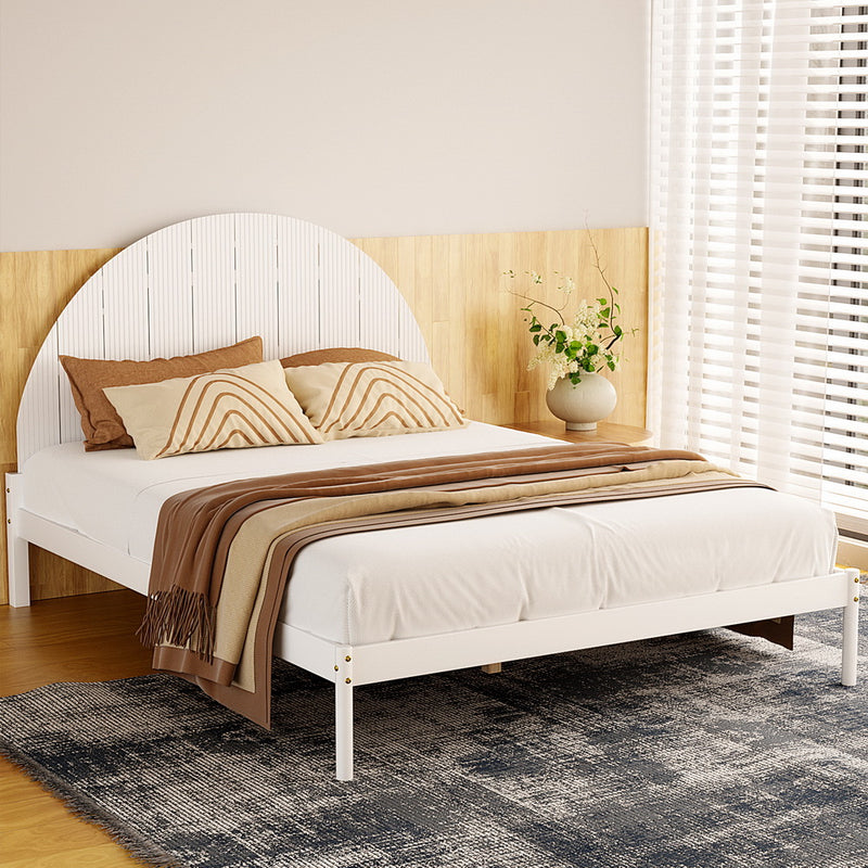 Daly Queen Wooden Bed Frame White with semicircular headboard, white frame, brown pillows, and beige throw in bedroom setting