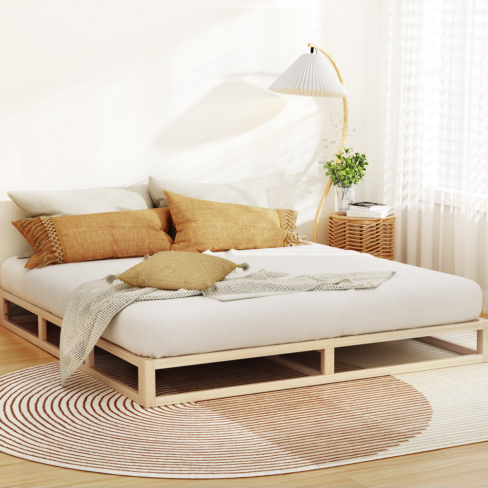Kalam Minimalist Solid Pinewood Bed Frame - King with neutral cushions, textured throw, lamp, and wooden side table in bedroom setting
