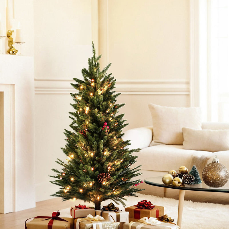 Mini 90CM LED Christmas Tree with warm lights, decorated with pinecones, standing beside wrapped gifts in living room setting