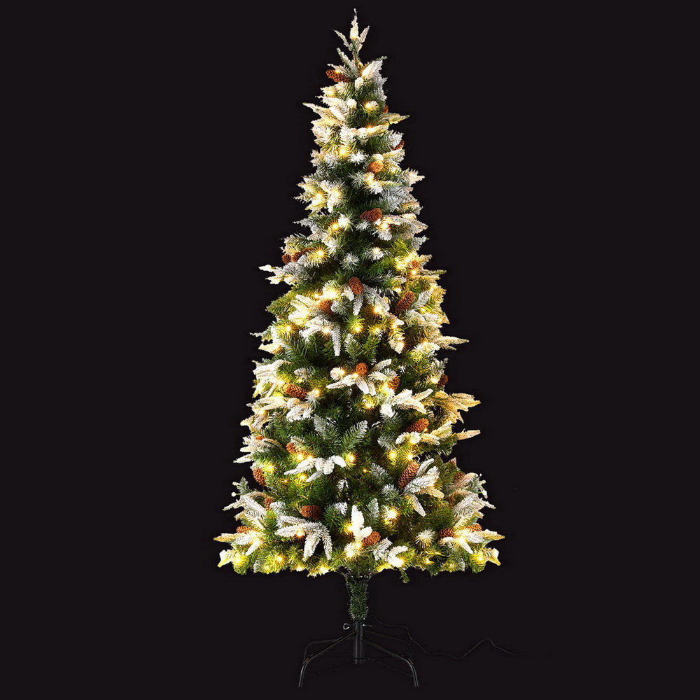 6FT / 1.8M Christmas Tree with snow flocked branches, pine cones, 680 tips, and pre-lit 280 warm white LED lights on black background