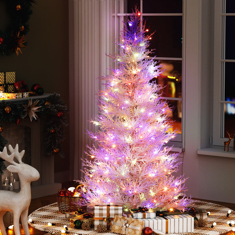 6FT / 1.8M Christmas Tree – Sparse White – 622 Tips – Pre-lit 200 Multi-Colour LED Lights glowing in cozy room setting with gifts underneath