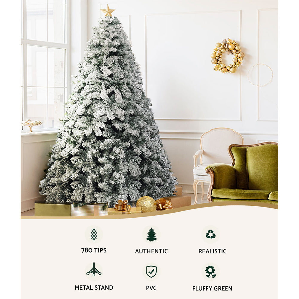 7FT / 2.1M Snow Flocked Christmas Tree – 859 Tips with snowy PVC branches, fluffy green look, and metal stand in cozy room setting