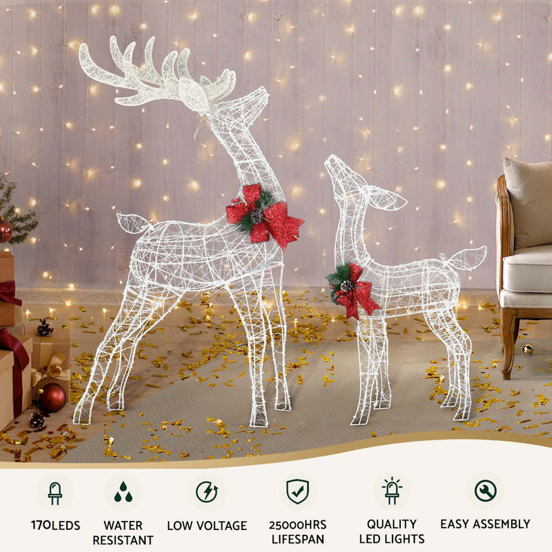 2 PCS Christmas Lights 170 LED Fairy Light Reindeer Decorations with red bows, set in a cozy room with warm string lights backdrop